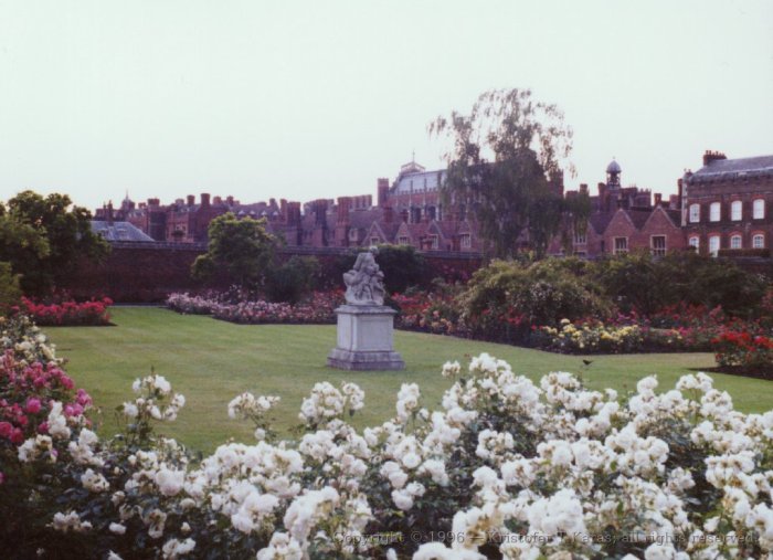 Flowers and a statue in the garden at Hampton Court, England