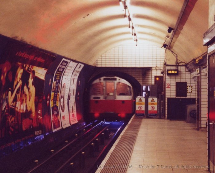 Tube train (with blue spark) entering Euston underground station, London
