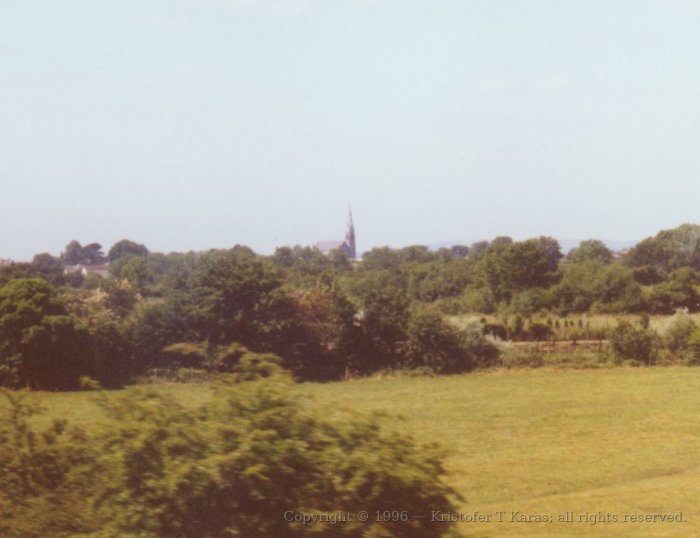 Country church seen through train window; Ireland.