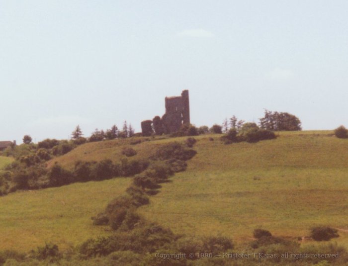 Distant ruins of a church as seen through railway carriage window; Ireland