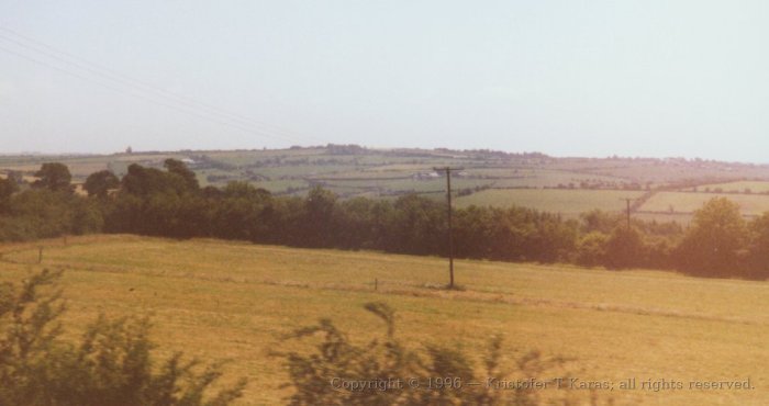 Power lines amidst rural Irish fields - a reminder of modern times