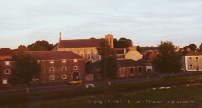 Late afternoon sun shines on trackside buildings; Dublin, Ireland