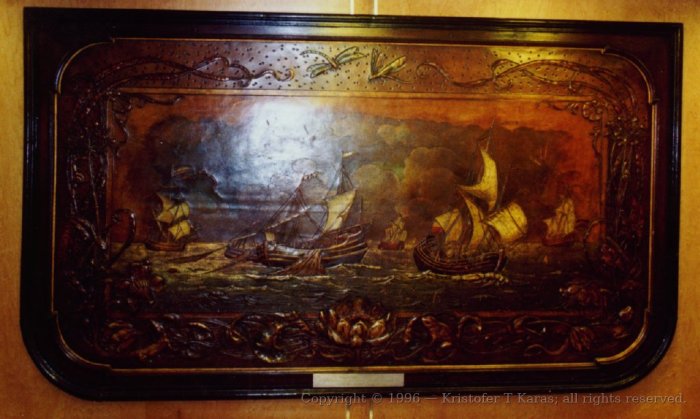 Leather panel, depicting sailing ships at sea, on wall of QE2
