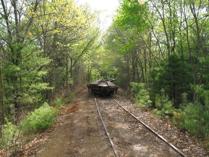 Several flatcars are stored on the Massachusetts Central ROW