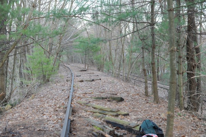A lone rail leads to the abutment of the Massachusetts Central overpass