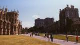 Visitors walk along path adjacent the chapel at Windsor Castle, England