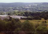 Welsh valley, Triumph warehouse in foreground, Wales