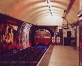 Tube train (with blue spark) entering Euston underground station, London
