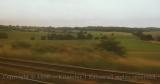 Green countryside seen through train window, England