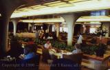 Passengers seated in one of the multi-purpose lounge areas aboard QE2