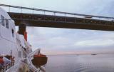 Queen Elizabeth II steams below a bridge en-route for the Hudson; New York